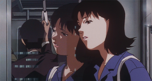 A GIF of an anime woman on an urban train with her head resting against the window. Her reflection changes to another version of her that turns and looks at her.