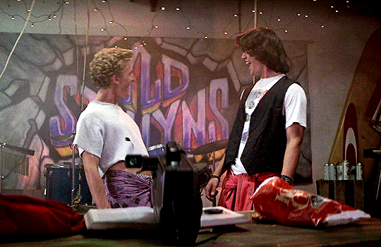 A GIF of two boys air guitaring