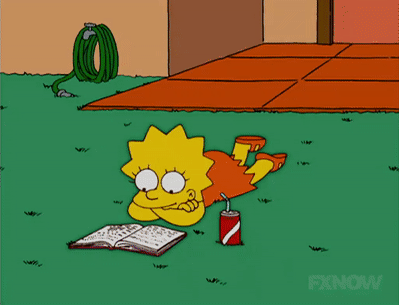 A GIF of Lisa Simpson lying on the grass, reading a book and swinging her leg